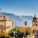 Buildings and trees against a mountain backdrop in the town of Taormina